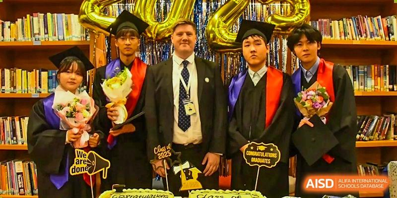 A teacher and two graduating students from AISB-Hope International posing for a photo at a graduation ceremony.