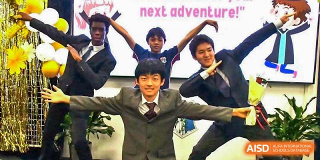 A group of AISB-Hope International students in school blazers striking a lively pose.