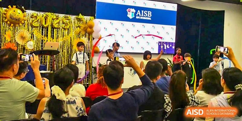 Students and teachers attending a vibrant school performance or event at AISB-Hope International.