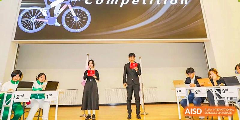 Two students standing on stage receiving awards or certificates during a competition or school ceremony at The Affiliated High School of Peking University's Dalton Academy.