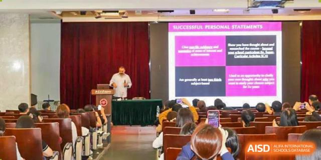 Students and teachers from The Affiliated High School of Peking University's Dalton Academy attending a presentation in a classroom, with a screen showing a slide titled "SUCCESSFUL PERSONAL."