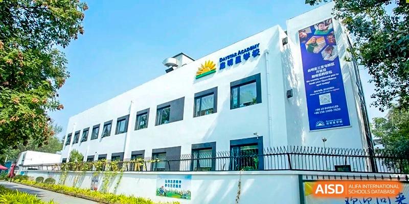 DAYSTAR ACADEMY white school building exterior with blue trim on a sunny day.