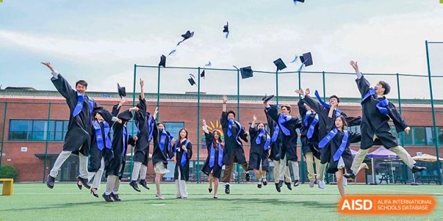 DAYSTAR ACADEMY graduates in caps and gowns celebrating and throwing their graduation caps into the air.