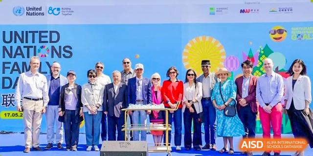 A group of dignitaries and staff standing on stage during a ceremony or event at DAYSTAR ACADEMY.
