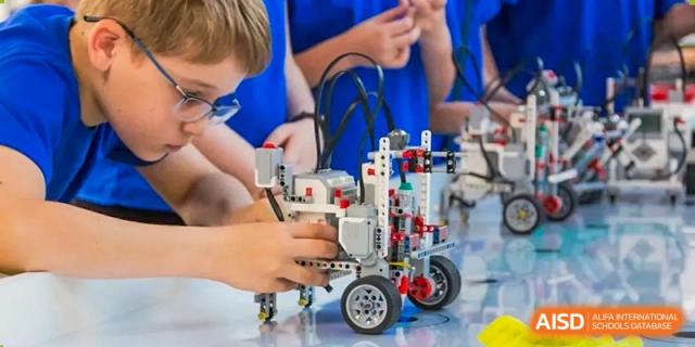 A close-up of a complex student-built robot on a table at Harrow Lide High School Nanning showing STEM education.