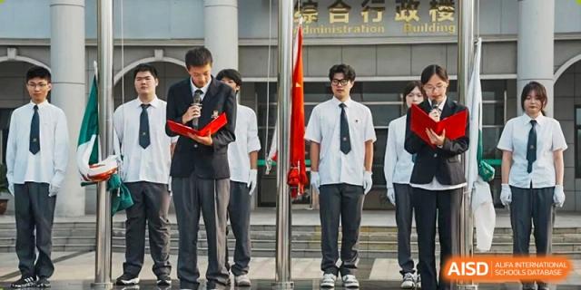 Three male students in different school uniforms standing near a set of stairs at Maple Leaf International School-Zhenjiang.
