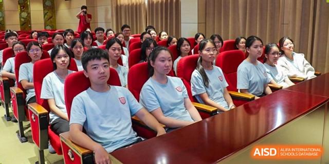 A close-up of female students in light blue shirts seated attentively in a lecture hall or conference room at Wuxi No.1 High School.