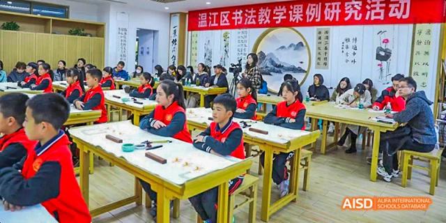 Students seated at traditional wooden desks practicing calligraphy or traditional Chinese writing in a classroom decorated with cultural elements, at 21ST Century School, Wenjiang, Chengdu.