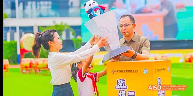 A student and an adult participating in a fun, hands-on science or construction challenge game, at 21ST Century School, Wenjiang, Chengdu.