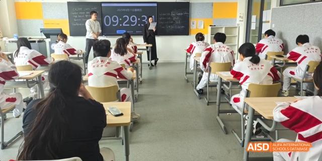 Students wearing uniforms taking a test or exam in a classroom under a strict time limit at BDA School of The High School Affiliated to Renmin University of China.