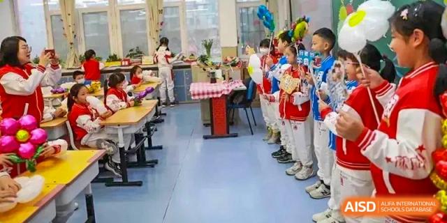 Students and staff standing along a colorful hallway or room, ready for an event or fair at BDA School of The High School Affiliated to Renmin University of China.
