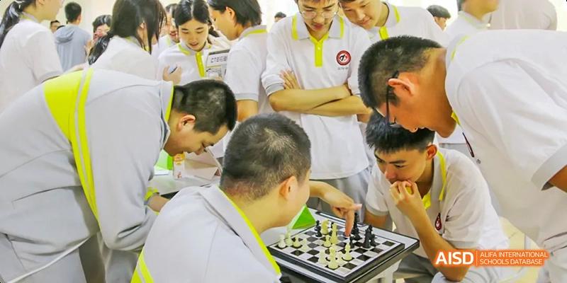 A student from Beijing No.2 Middle School playing a game of chess with an adult mentor or teacher.