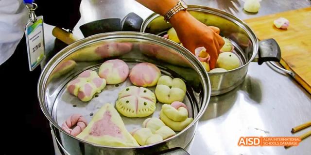 A close-up of colorful and decorative steamed buns, prepared by students from Beijing No.2 Middle School as part of a health and nutrition or cooking class.