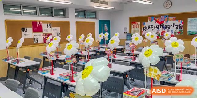 An empty classroom at The International School of Rhodes decorated with white flower balloons for a special event or celebration.