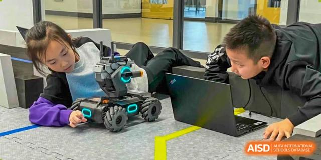 Close-up of robotics equipment or a small programmable robot on the floor in a lab or classroom at Tsinghua International School Daoxiang Lake.