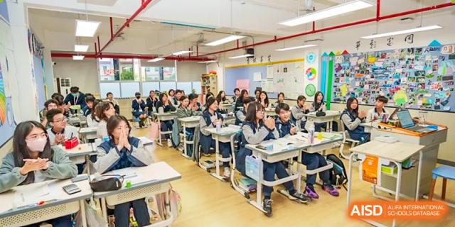 A wide view of an active classroom full of students at their desks in the Affiliated School of JNU for Hong Kong & Macao Students.
