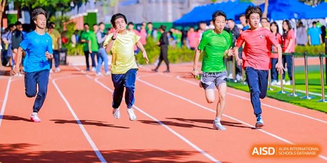 Students from the Affiliated School of JNU for Hong Kong & Macao Students running a race on the school's track during a sports meet.