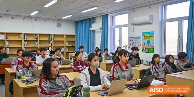Students seated at desks and using laptops during a focused classroom session at Beijing Academy International Department (BAID).