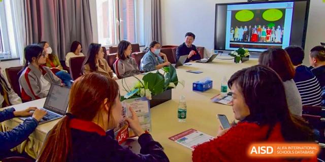 Students seated around a large circular table, participating in an intensive seminar or discussion session at Beijing Academy International Department (BAID).