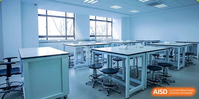 A bright, modern science laboratory classroom at Boya International Academy (BIA) with tables, stools, and large windows.