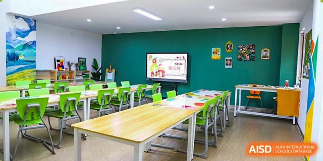 A brightly lit, modern early years or primary classroom at Boya International Academy (BIA) with flexible seating and an interactive digital display.