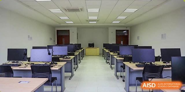 An expansive computer lab at Boya International Academy (BIA) featuring rows of computers and individual desks for students.