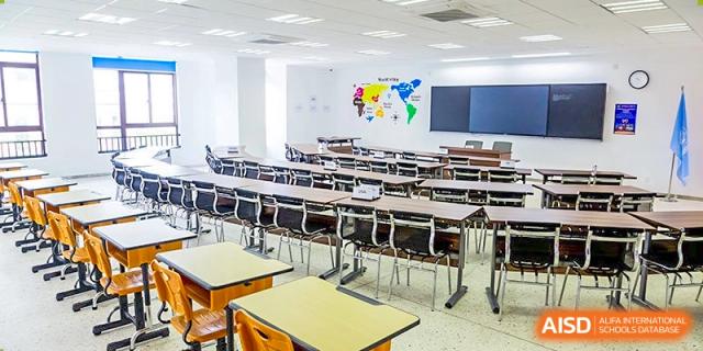 A large lecture hall or auditorium classroom at Boya International Academy (BIA) with tiered seating and a world map display on the wall.