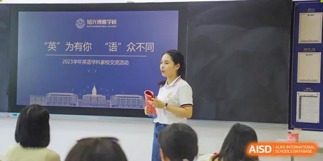 A female teacher at Boya International Academy (BIA) presenting to students in front of a digital screen displaying a Chinese phrase and the school logo.