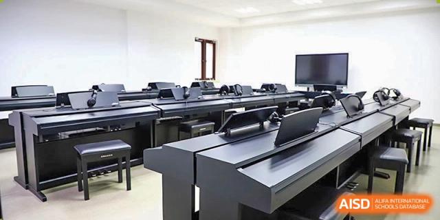 An indoor music classroom or piano lab at Boya International Academy (BIA), equipped with multiple digital keyboards or pianos for student practice.