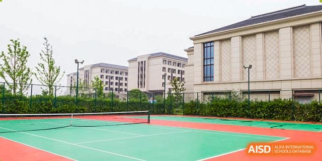 An outdoor tennis or multi-purpose court situated next to the residential or faculty buildings at Boya International Academy (BIA).