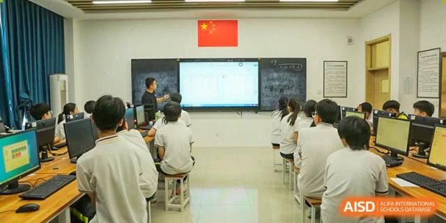 A classroom scene with a teacher using a smart board at the front and students seated and listening attentively, Brilliant Light School SJZ.