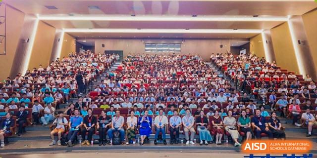 A large group of students and teachers gathered for a school assembly or ceremony in an auditorium, Brilliant Light School SJZ.