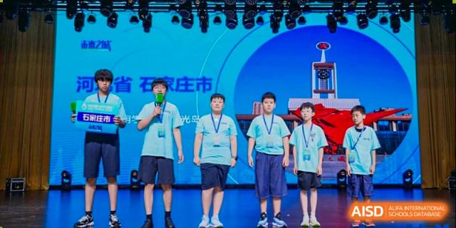 Four male students standing on a stage during an event, possibly a competition or awards ceremony, Brilliant Light School SJZ.