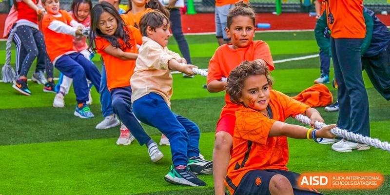 Young students from Changchun American International School (CAIS) participating in a tug-of-war game.