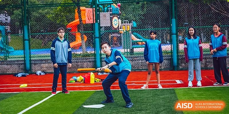 An activity instructor leading students in a fun fitness or sports drill at Changchun American International School (CAIS).