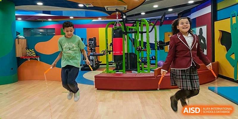 A student from Changchun American International School (CAIS) jumping in a gymnasium during a physical activity session.