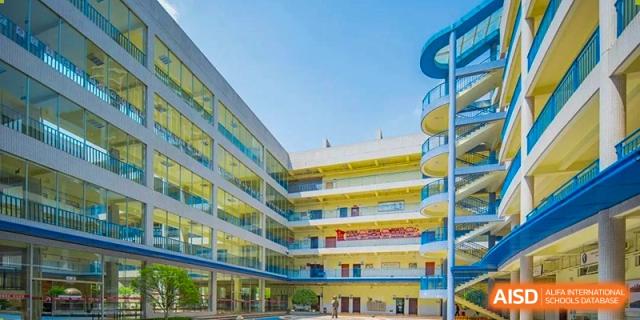 The central courtyard and multi-story academic buildings of the school, featuring modern architecture and a bright, open learning environment at Guiyang New World School.