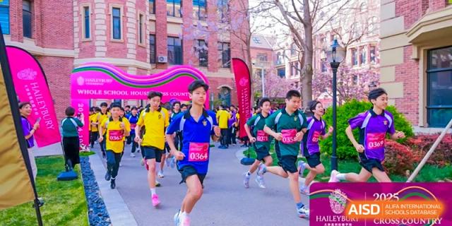 A group of students running in a race on a path near the iconic brick buildings of Haileybury Schools, Tianjin.