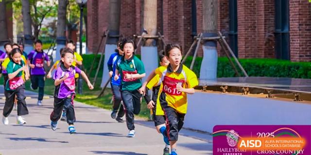 Two students in bright yellow and green shirts running competitively on the school grounds at Haileybury Schools, Tianjin.