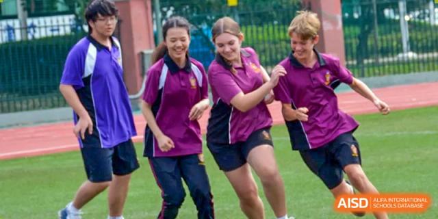 Male and female students in purple sports gear participating in an outdoor physical education or sports activity at Haileybury Schools, Tianjin.