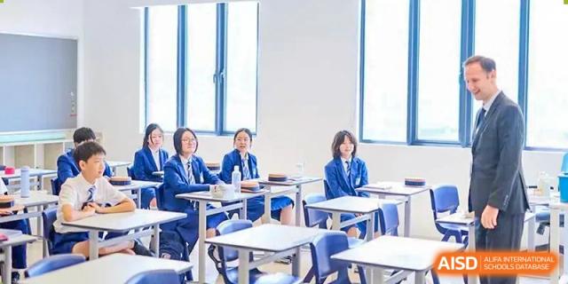 Students in uniform seated at desks, actively engaged in a classroom lesson at Harrow LiDe School Chongqing (AISL Harrow Chongqing).