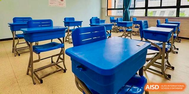 A small cluster of blue desks and chairs in a classroom, showing a flexible learning setup at the  Hefei No.6 High School International Department.