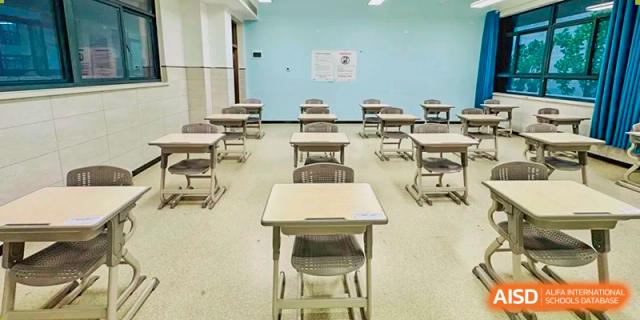 Rows of empty student desks and chairs in a standard classroom setting at the  Hefei No.6 High School International Department.
