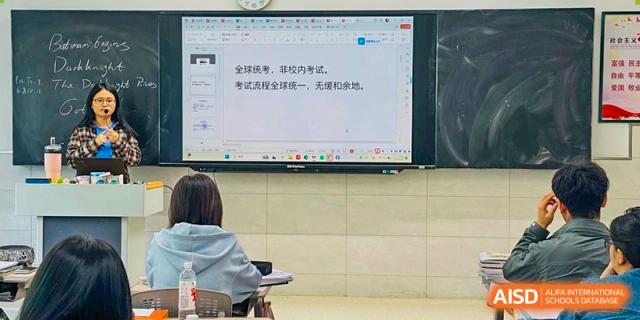 A student seated at a desk facing a large digital whiteboard with Chinese text displayed during a lesson at the  Hefei No.6 High School International Department.