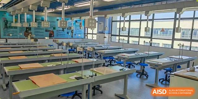 An empty, well-equipped science or engineering classroom with individual desks and specialized apparatus mounted on walls Hefei No.6 High School International Department.