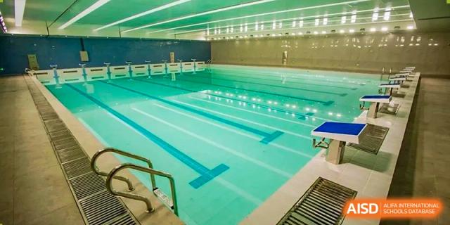 The empty indoor swimming pool with clearly marked lanes, showcasing the aquatic facilities at the  Hefei No.6 High School International Department.