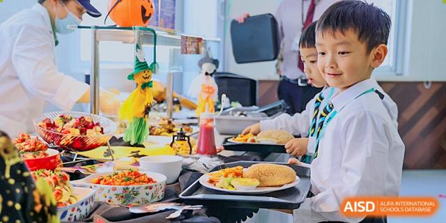 Students from Hiba Academy Nantong gathered around a buffet or table filled with various foods, possibly during a school meal or event.
