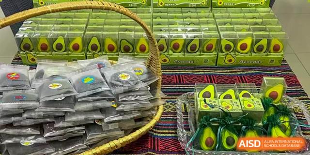 A close-up of a basket filled with packaged avocado products at a market or vendor display at Kunming International Academy.