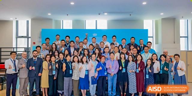 A large group photo of Nord Anglia Chinese International School Shanghai faculty, staff, and leadership posing together at a school event.