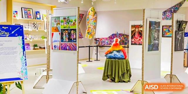 An indoor gallery space at Nord Anglia Chinese International School Shanghai showcasing bright, colorful student artwork and sculptures.